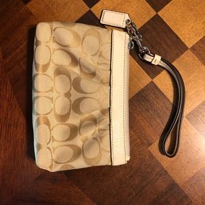 Tan and cream Coach wristlet